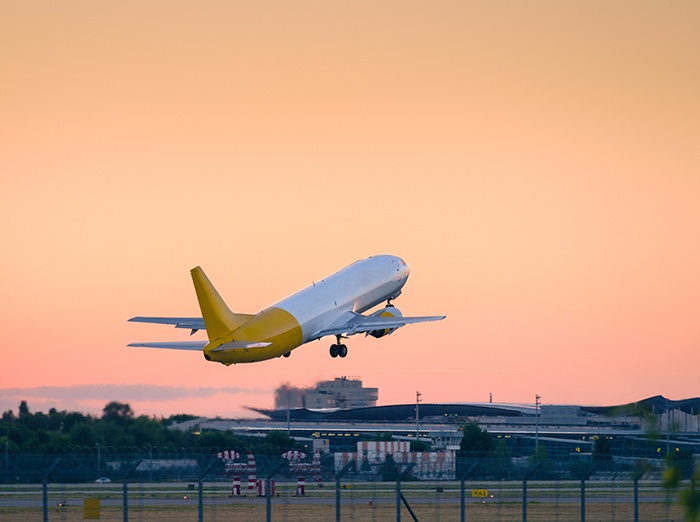 Airplane departing from runway at sundown