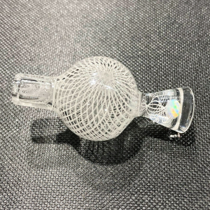 Mycomann engraved glass bubble cap with opal handle against gray surface.