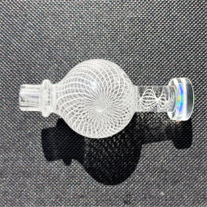 Intricately engraved glass bubble cap with opal handle by Mycomann - pictured against gray surface.
