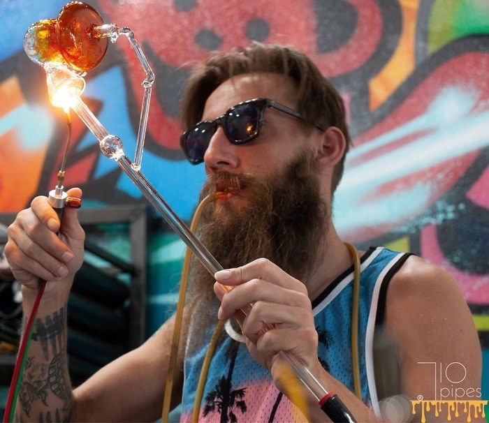 Denver glass artist Honey Badger Glass Worx making heady glass dab rig with torch at Northglenn smoke shop