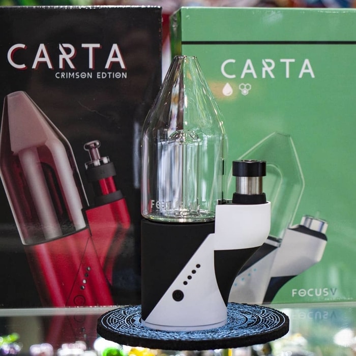 Focus V Carta smart dab rig in white and packaging on countertop at 710 Pipes smoke shop in Denver, CO