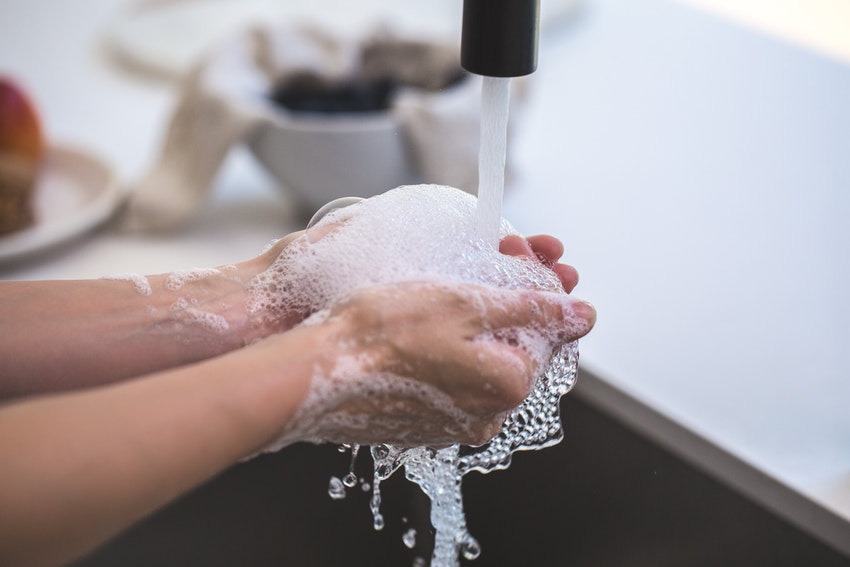 Smoker Washes Hands in Soapy Water After Cleaning Residue from Favorite Hand Pipe