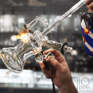Close-up of a torch flame shaping a glass joint at 710 Pipes Studios