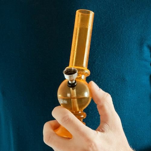 Orange glass bong in hand