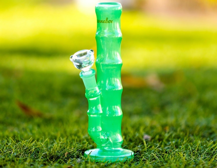 Lime green bong in grassy field on sunny day
