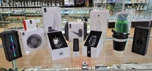 Assortment of Puffco product boxes displayed on a glass store counter