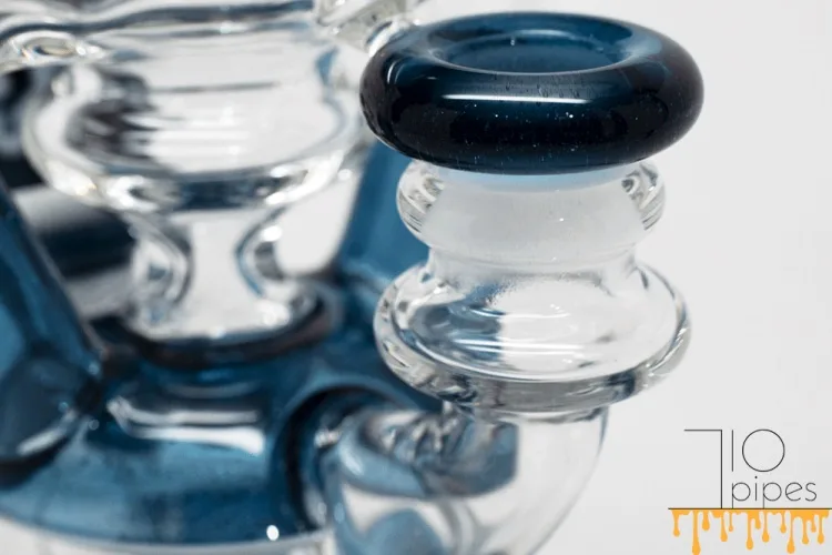 Close-up of blue mouthpiece and transparent chamber of heady glass bong
