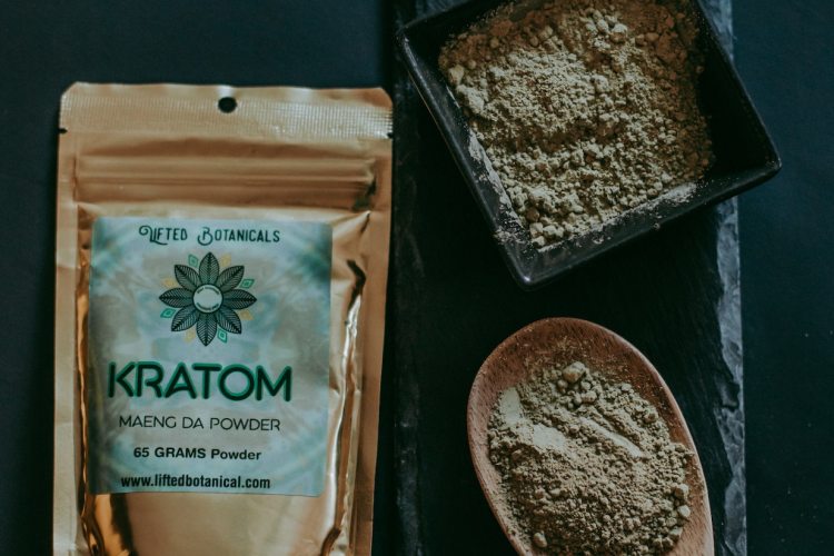 Kratom in bag beside kratom powder in adjacent scoops