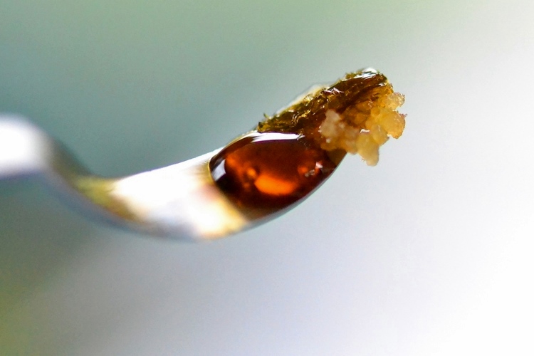 Dab of wax concentrate on tip of metal dabbing tool