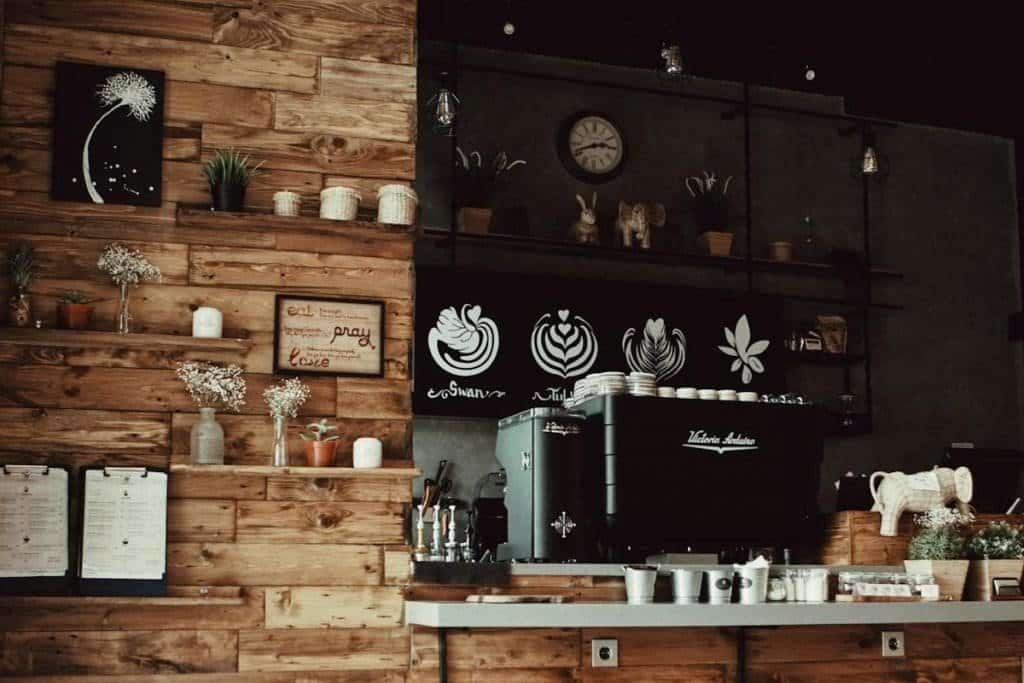 Coffeeshop countertop with white mugs and espresso machine