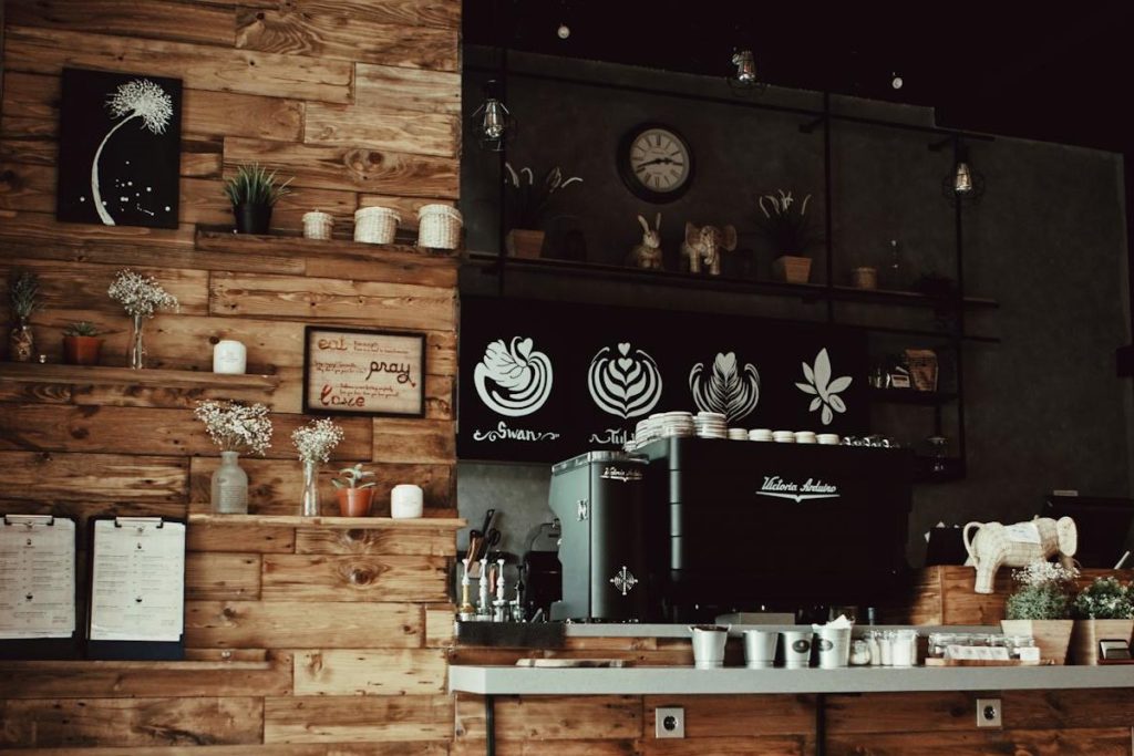Coffeeshop countertop with white mugs and espresso machine