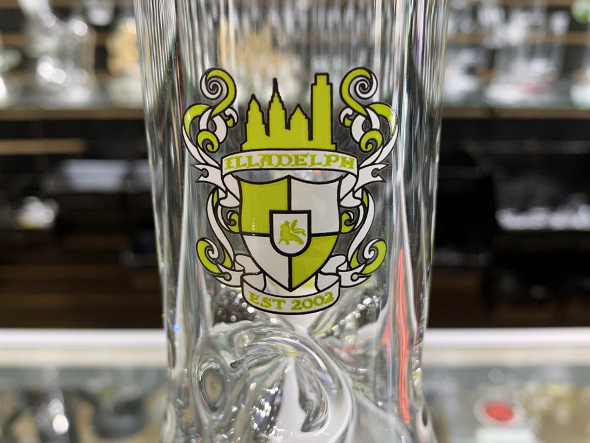 Illadelph Glass emblem on translucent glass bong in smoke shop