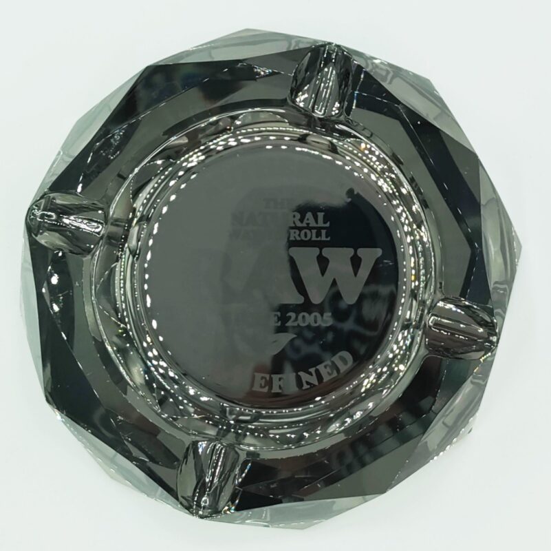 Black faceted glass ashtray with cigar rests and engraved lettering