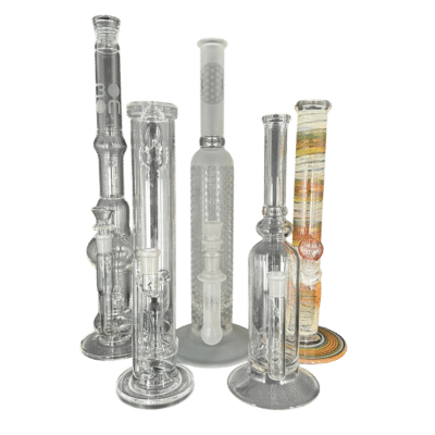 Assortment of tall glass water pipes and bongs in clear, smoky and fumed colors