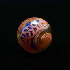 Charisma glass marble number 3, blue and orange spiral pattern