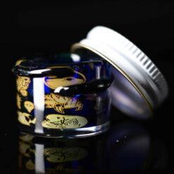 Empty1 Laser Micro Jar number 3 in cobalt blue and gold, angled view with lid off