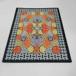 Moodmats Riel, rectangular mat with an orange and blue geometric pattern