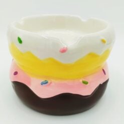 Donut-shaped ceramic ashtray with pink frosting and sprinkles