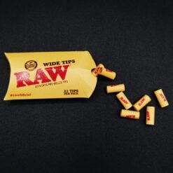 RAW Pre-Rolled Wide Tips pack with loose tips scattered in front