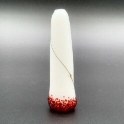 Joker Spliff Chillum in white with a red speckled tip, standing upright