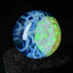 Kadabra Opal Marble, blue and green glowing opal glass marble, angled view
