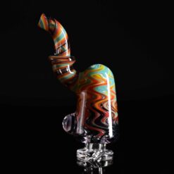 Keys Glass Pivot Top #3, orange swirled glass top attached to a black base, side view