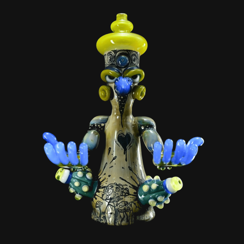 Aaron Brooks heady figural glass pipe with blue hands and a yellow head cap