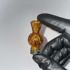 Mothership Bubble Cap 1 in amber, glass spinner carb cap held in hand