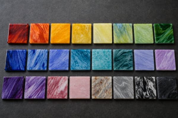 Test tiles of striking and reactive borosilicate glass showing color variation